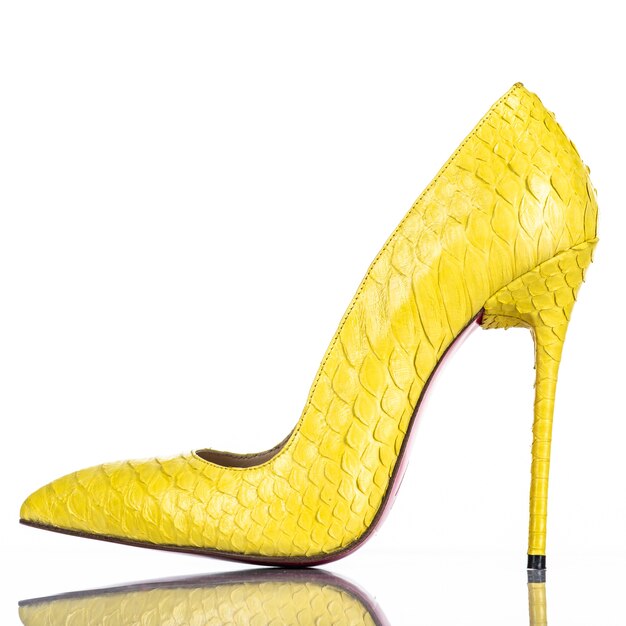 Fashionable woman's high heel shoe isolated on white background. Beautiful yellow female high heels shoe. Luxury.