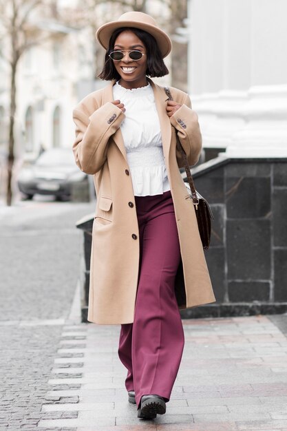 Fashionable woman taking a walk outdoors