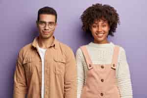 Free photo fashionable young man and woman posing