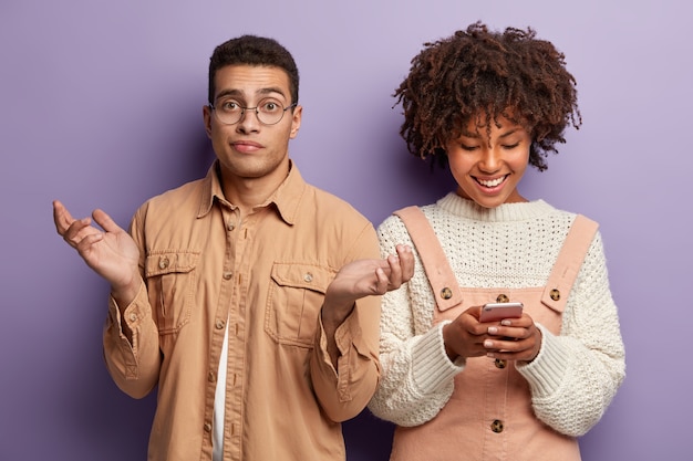 Fashionable young man and woman posing