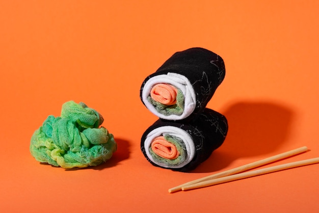 Fast fashion concept with materials and textiles disguised as sushi rolls