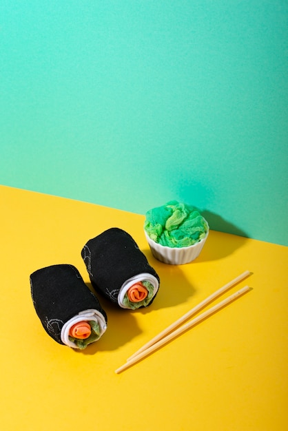 Free photo fast fashion concept with materials and textiles disguised as sushi rolls