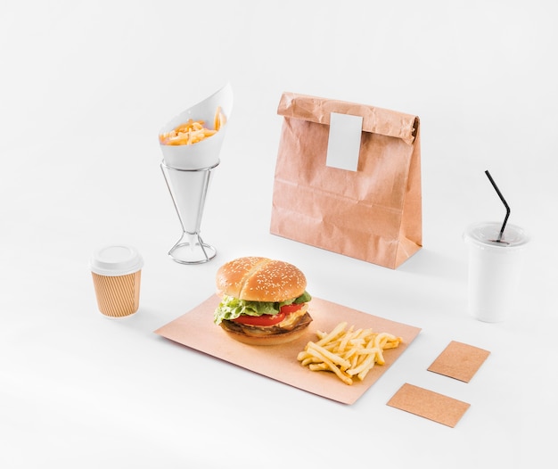Fast food; disposal cup and parcel on white surface