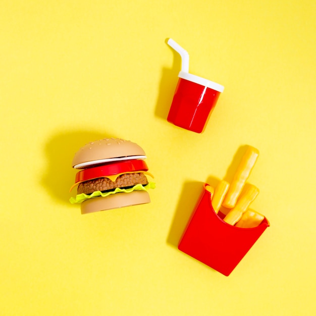 Fast food replicas on yellow background