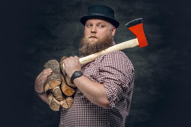 Free photo fat bald, bearded man holds an axe and fire woods.