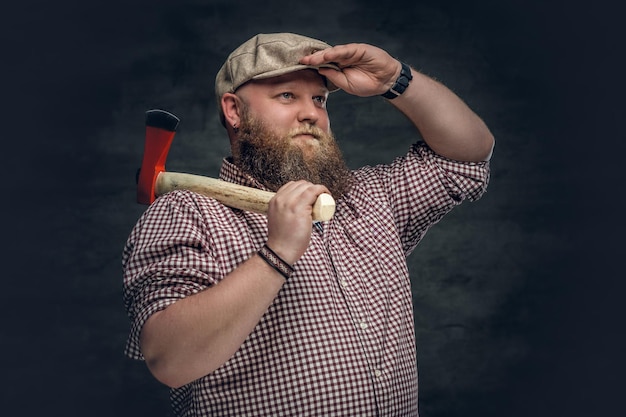 Fat bald, bearded man holds an axe and fire woods.