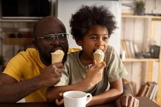 無料写真 台所で一緒にアイスクリームを持っている父と息子