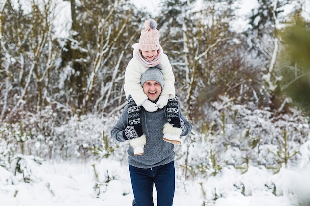 Father carrying daughter on neck