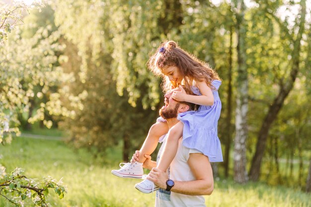 Father carrying her daughter on shoulders