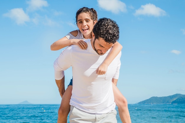 Father carrying his daughter