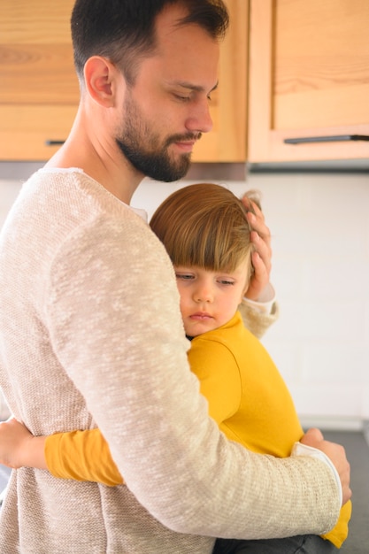 Free photo father and child hugging each other