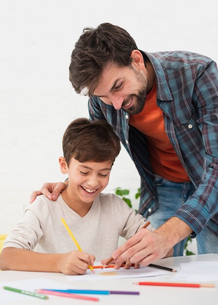 Father coloring with his cute son