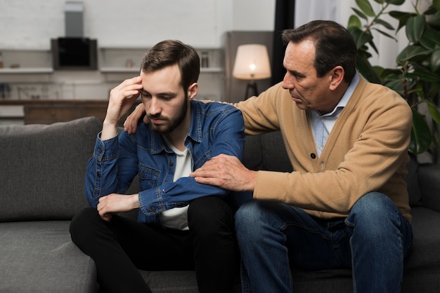 Free photo father comforting adult son