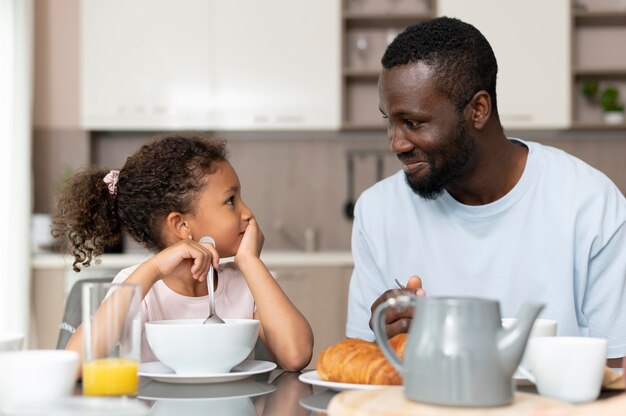 Father and daughter eating together