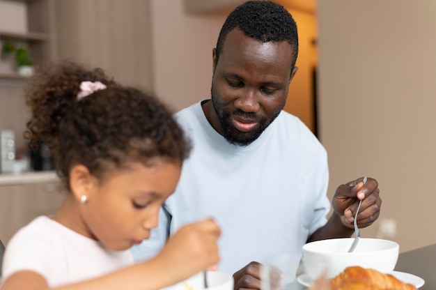 Father and daughter eating together