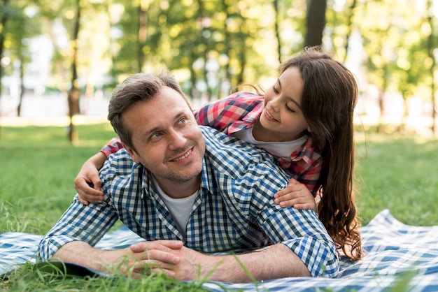 Father and daughter having fun in park