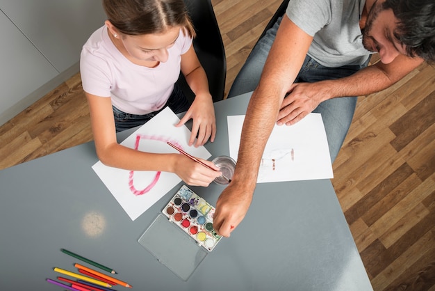 Father and daughter painting together on fathers day