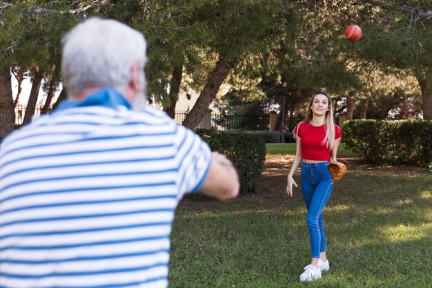 Father and daughter playing baseball