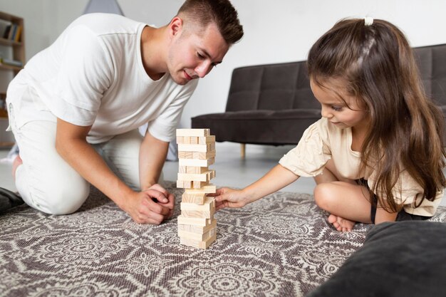 Father and daughter playing a game together