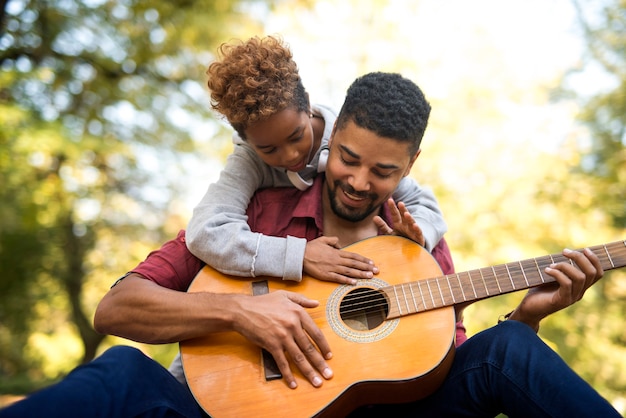 Отец и дочь вместе играют на гитаре