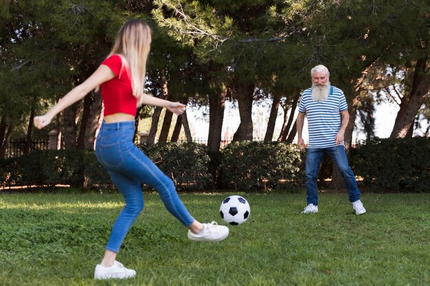 Father and daughter playing soccer