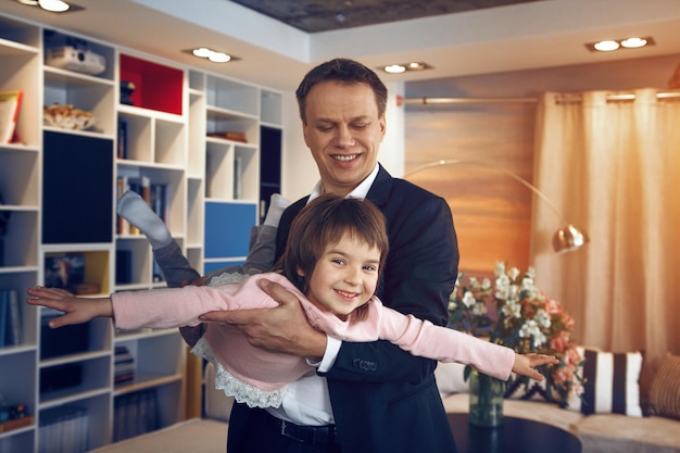 Father and daughter playing together at home