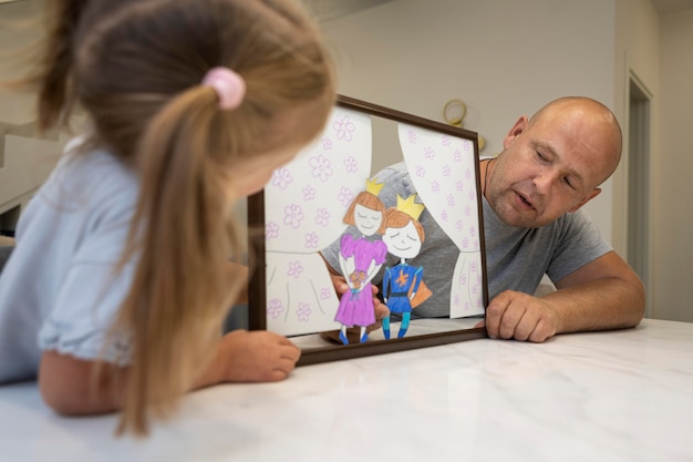 Father and daughter playing with puppets