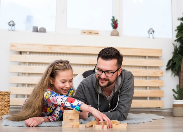 Father and daughter playing with wood blocks