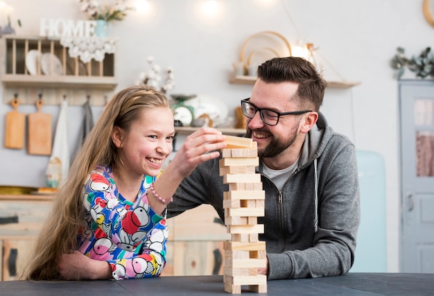 Father and daughter playing with wood blocks