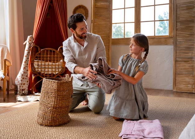 Free photo father and daughter spending time together while wearing linen clothing