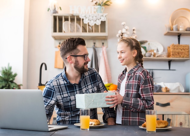 Father and daughter together on breakfast table