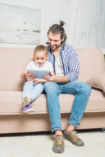 Father and daughter using the tablet