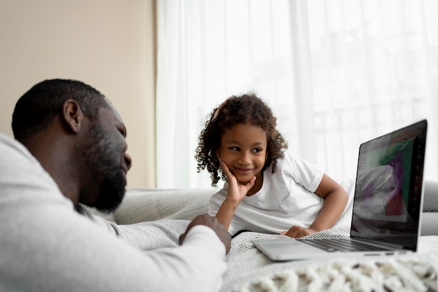 Father and daughter watching a movie on a laptop