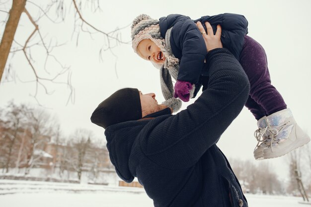 Father and daughter in a winter park