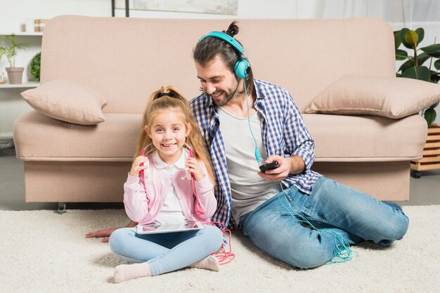 Father and daughter with earphones