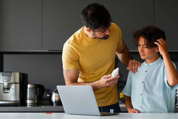 Free photo father helping boy with lice medium shot