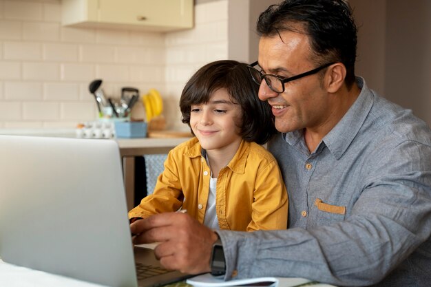 Father helping his son in online class