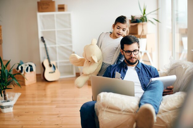 Father and his small daughter moving into a new apartment