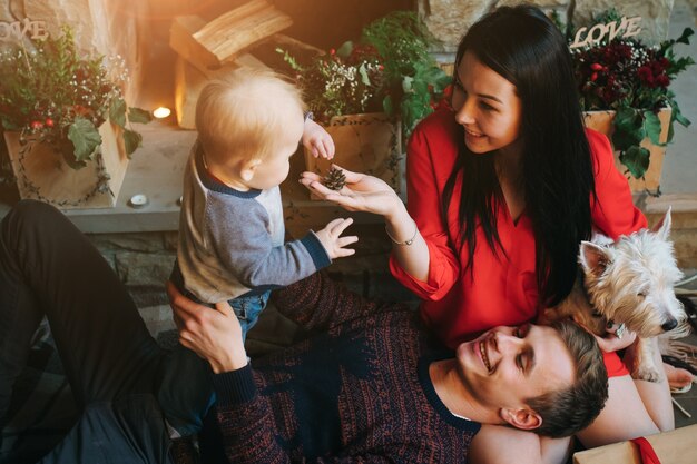 Father holding baby up while his wife looks at them