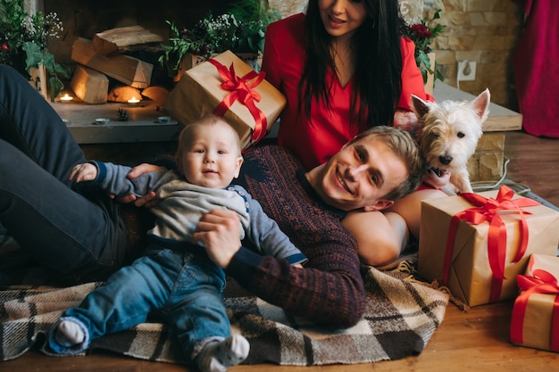 Father holding baby up while his wife looks at them