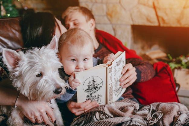 Free photo father holding a book where the baby is leaning