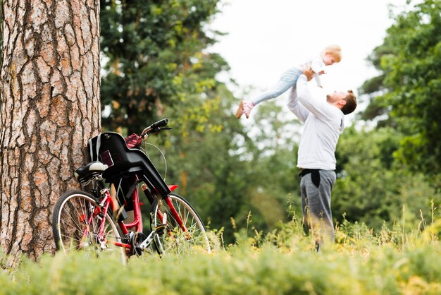 Father holding daughter in the air