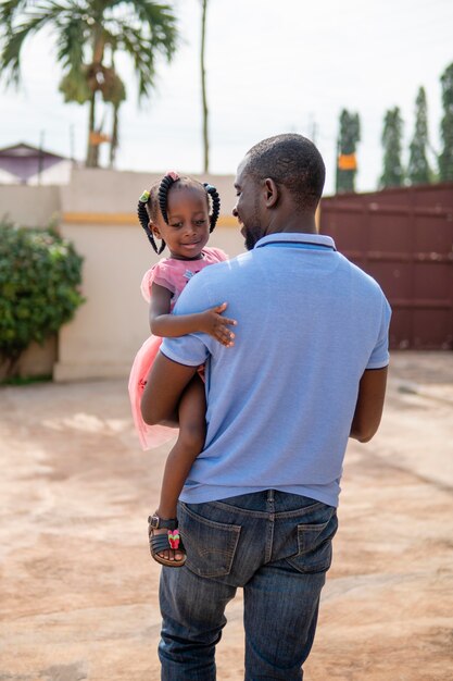 Father holding his little black girl