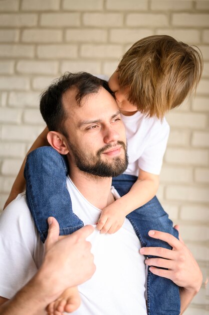 Father holding kid on shoulders