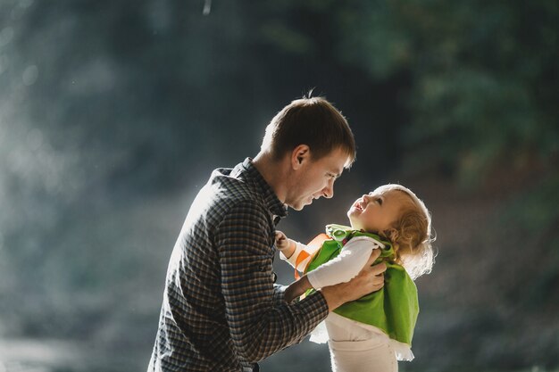 Free photo the father holds of hands his daughter in the park