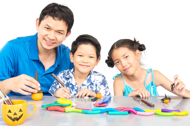 Father is playing clay toy with kid