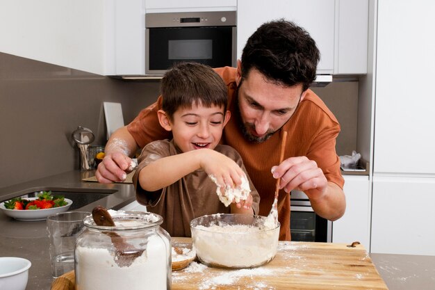 Father and kid cooking together