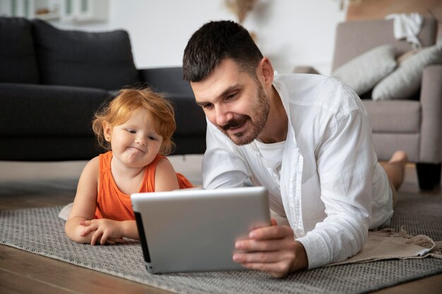 Отец и ребенок с полным планом планшета