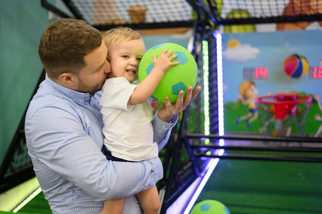 Father kissing son in playground