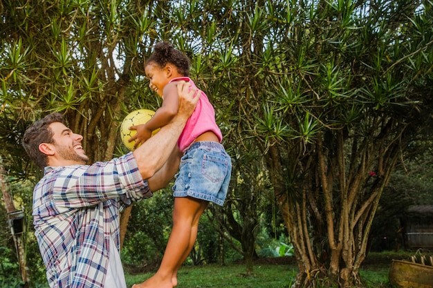 Father lifting daughter